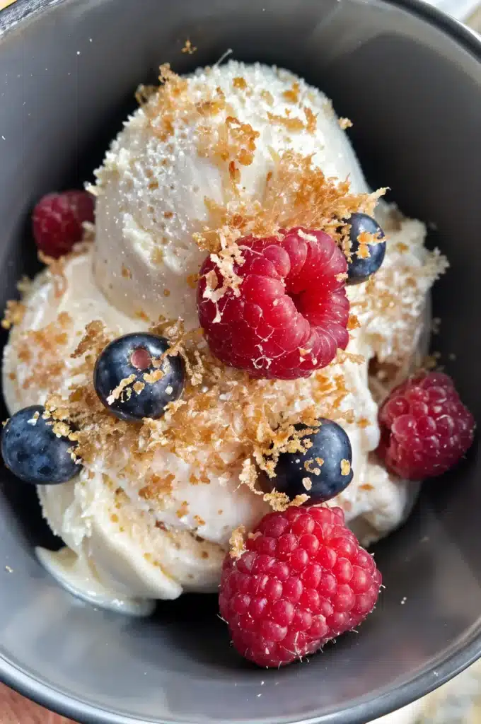 Creamy Coconut Milk Ice Cream – Dairy-Free, No-Churn Recipe 7 Coconut milk ice cream topped with fresh berries and coconut flakes.