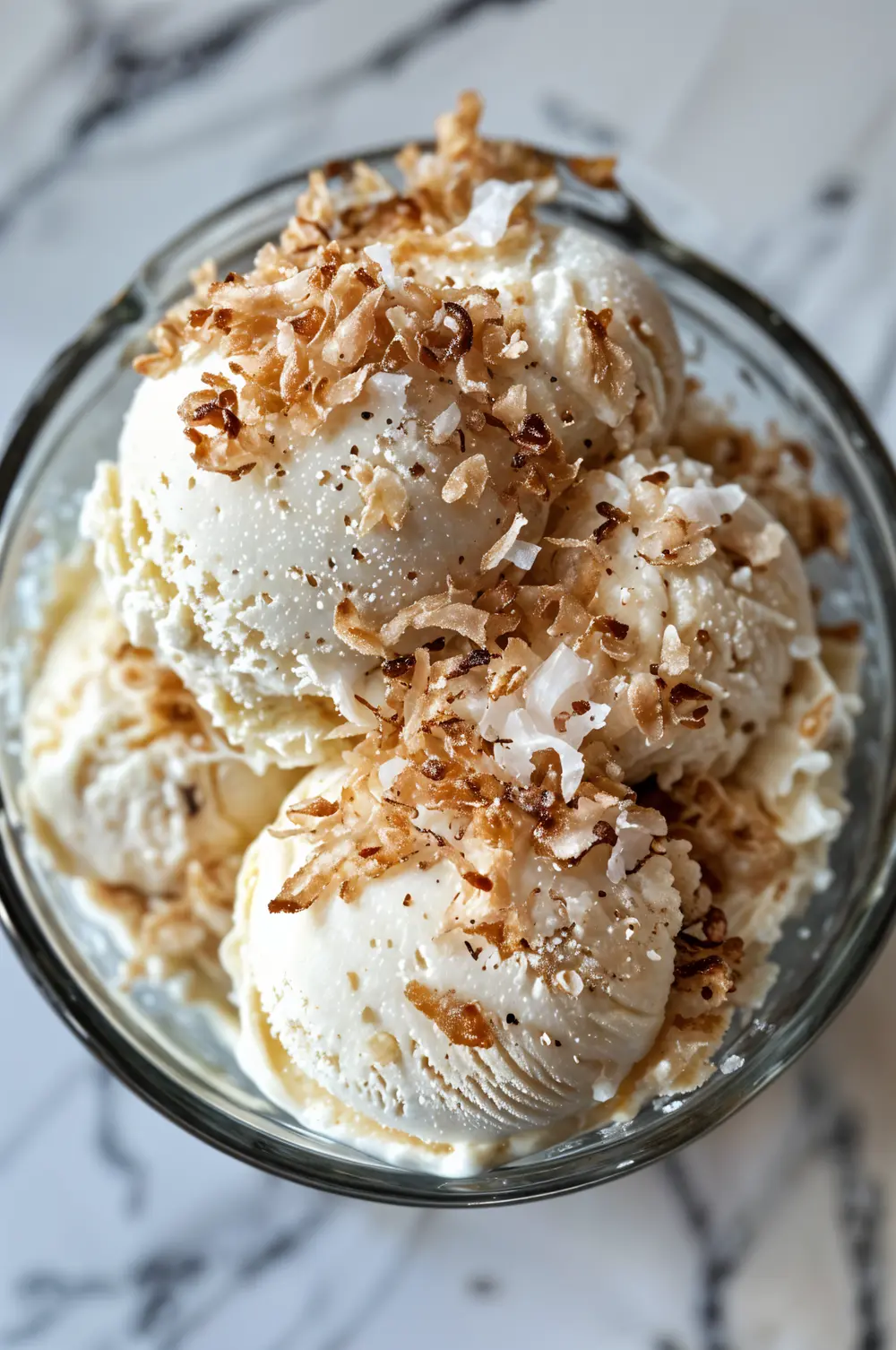 Creamy Coconut Milk Ice Cream – Dairy-Free, No-Churn Recipe 8 Creamy coconut milk ice cream scoops in a bowl.